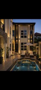 a large house with a swimming pool in front of it at Richcastle Hotel in Freetown +34 photos