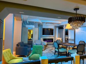 a living room with colorful chairs and a table at Richcastle Hotel in Freetown
