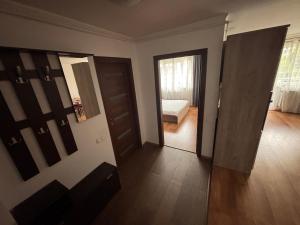 a room with two doors and a bedroom with a bed at Mio Apartments Silver in Cluj-Napoca