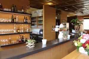 a bar in a restaurant with glasses on the shelves at Landgasthof 'Zur Quelle' in Wächtersbach