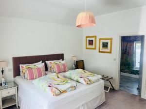 a white bed with pillows on it in a bedroom at Lavally House in Gort