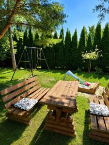 a picnic table and a swing set in a park at Pokoje na Brzozowej 2 in Białogóra