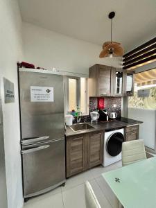 a kitchen with a stainless steel refrigerator and a dishwasher at Next to beach Sliema Stay, Cozy, Air-Conditioned, Self Check-In in Il-Gżira +8 photos