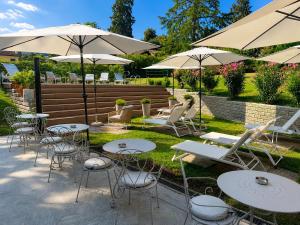 a group of tables and chairs with umbrellas at Villa Valesca in Stresa +5 photos