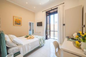 a bedroom with a bed and a large window at VILLA AGOSTINO LUXURY B&b in Vico Equense