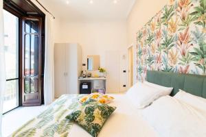 a bedroom with a bed with a floral wall at VILLA AGOSTINO LUXURY B&b in Vico Equense