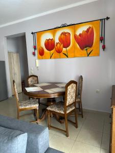 a dining room with a table and chairs and a painting at Artistic Retreat in Nafplio