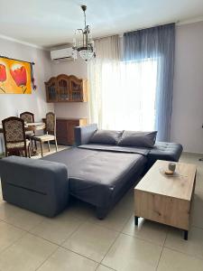 a bedroom with a blue bed and a table at Artistic Retreat in Nafplio