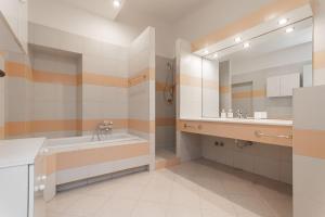 a bathroom with a tub and a sink and a mirror at "Fiordolce" a due passi dal mare in Vado Ligure +51 photos