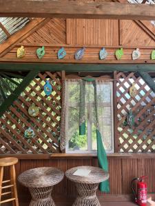 a wooden cabin with two tables and a window at Pensjonat i domki Kresy in Pogorzelce