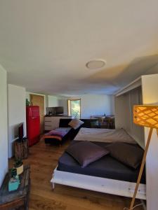a bedroom with two beds and a living room at Waldnest in Grächen