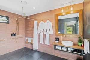 a bathroom with a sink and a mirror at Jinibara Cottage in Conondale