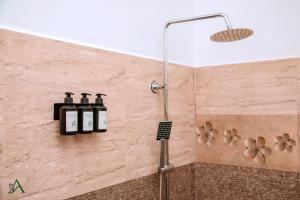 a shower with three bottles on the wall at Harohi Hotel and Residence in Negombo +35 photos