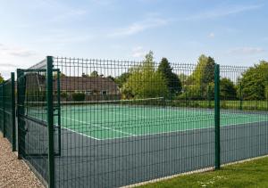 a tennis court with a net at Plgs and Blankets in Pucklechurch
