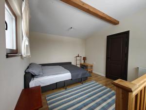 a bedroom with a bed with a blue striped rug at Gyulak Guesthouse in Izvoare