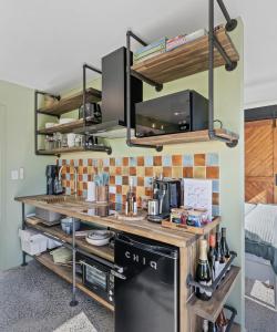 a kitchen with a counter with a stove at Jinibara Cottage in Conondale +15 photos