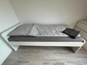 a bed in a room with a white bed frame at Monteurunterkunft Mosbach in Mosbach