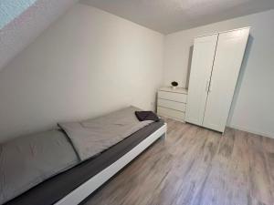 a small bedroom with a bed and a cabinet at Monteurunterkunft Mosbach in Mosbach +13 photos