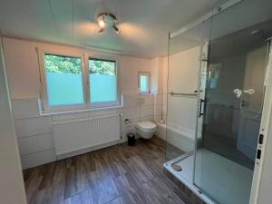 a bathroom with a glass shower and a toilet at Monteurunterkunft Mosbach in Mosbach