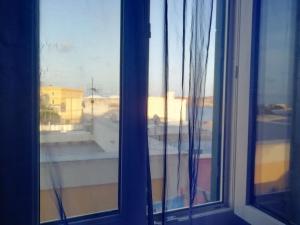 a window with a view of a balcony at Casetta Calanave in Ventotene