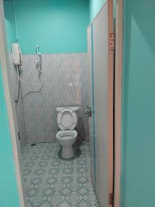 a bathroom with a toilet and a shower stall at Saran Resort room 3 in Ban Khok Wat