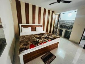 a bedroom with a bed and a large window at Kaushalya River View in Solan +3 photos