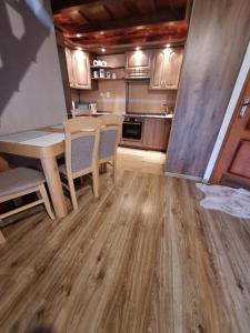 a kitchen with a table and chairs in a room at Apartmán Bianka in Rabča