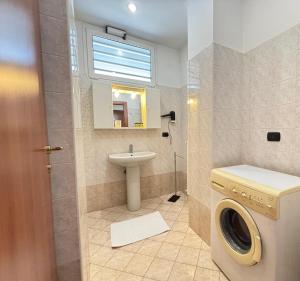 a bathroom with a washing machine and a sink at Residence Oasi Di Monza in Monza +119 photos