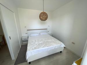 a bedroom with a bed and a pendant light at Frida in VeliGolji