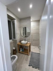 a bathroom with a toilet and a sink and a mirror at Frida in VeliGolji