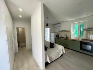 a bedroom with a bed and a kitchen with a counter at Frida in VeliGolji +2 photos