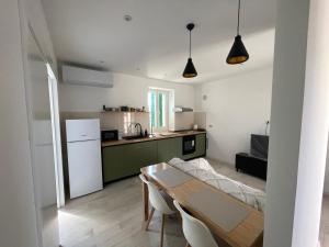 a kitchen with a table and a kitchen with a refrigerator at Frida in VeliGolji