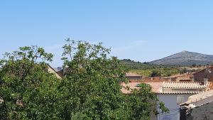a view of a town with a mountain in the background at les hirondelles de Barrou in Saint-Jean-de-Barrou +6 photos