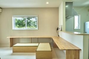 a bench in a kitchen with a window at 甘口派Stay in Tsurumakida