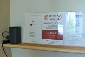 a shelf with two signs and a speaker on it at 甘口派Stay in Tsurumakida
