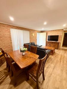 a living room with a table and a couch at Good price Apartment self check-in in Geraldton