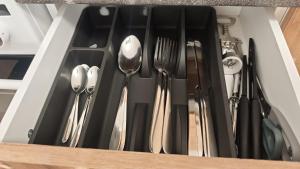 a drawer filled with silver utensils at Apartmán pro 3 osoby, Most M3 in Most