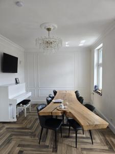 a dining room with a table and a piano at Villa Beckurts in Wernigerode