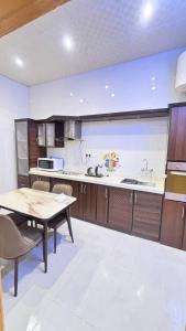 a large kitchen with a table and a dining room at شقق مفروشة الباحة in Al Baha