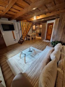 a living room with a couch and a glass table at Apartmán Bianka in Rabča