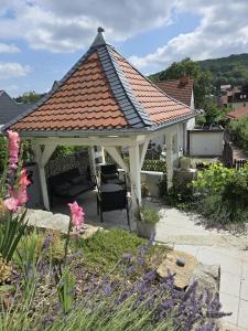 a white gazebo with a red roof at Villa Beckurts in Wernigerode