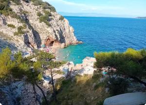a view of a beach with people in the water at Apartman Batelan in Brseč +5 photos