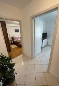 an open door to a room with a bedroom at Apartman Batelan in Brseč