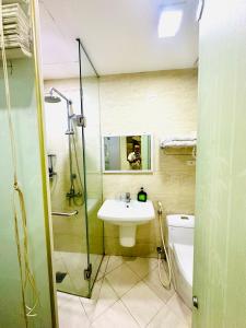 a bathroom with a shower and a sink and a toilet at Hanoi Better Hotel & spa in Hanoi +9 photos