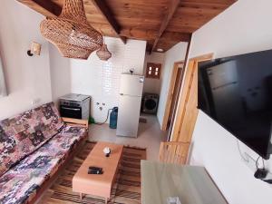 a living room with a couch and a table and a television at The Castle Hotel & studios in Dahab