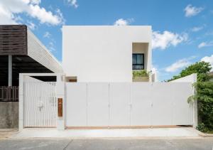 a white fence in front of a house at Villa Mar Pool Villa in Sathani Hat Yai