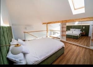 a bedroom with a large bed and a mirror at Hanul Pelerinului Cepari in Cepari Ungureni