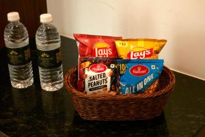 a basket of snacks and water bottles on a counter at Clickon Value Seven Hills in Chik Bānavar