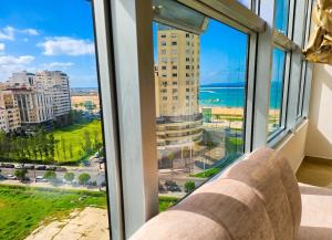 a room with a large window with a view of the ocean at panoramic sky 17 in Tangier