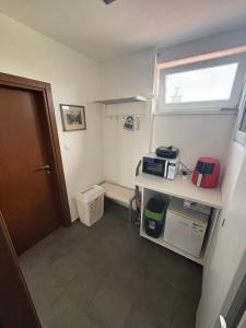 a room with a bathroom with a window and a door at apartman pri X Bionic Sphere Samorin 6 km od Casino Card Hotel in Blatná na Ostrove